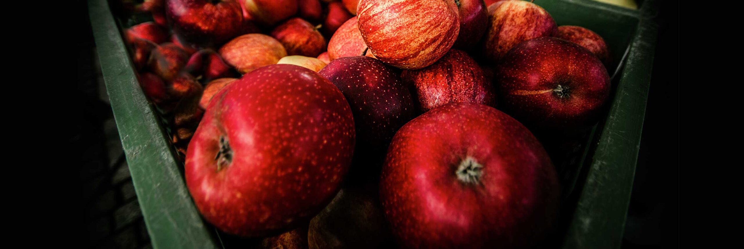 aboutmasthead crate full of red apples